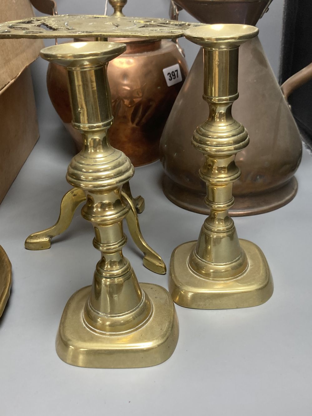 Miscellaneous metalware, including a copper kettle, two pairs of brass candlesticks, a squirrel trivet, tobacco box, etc.